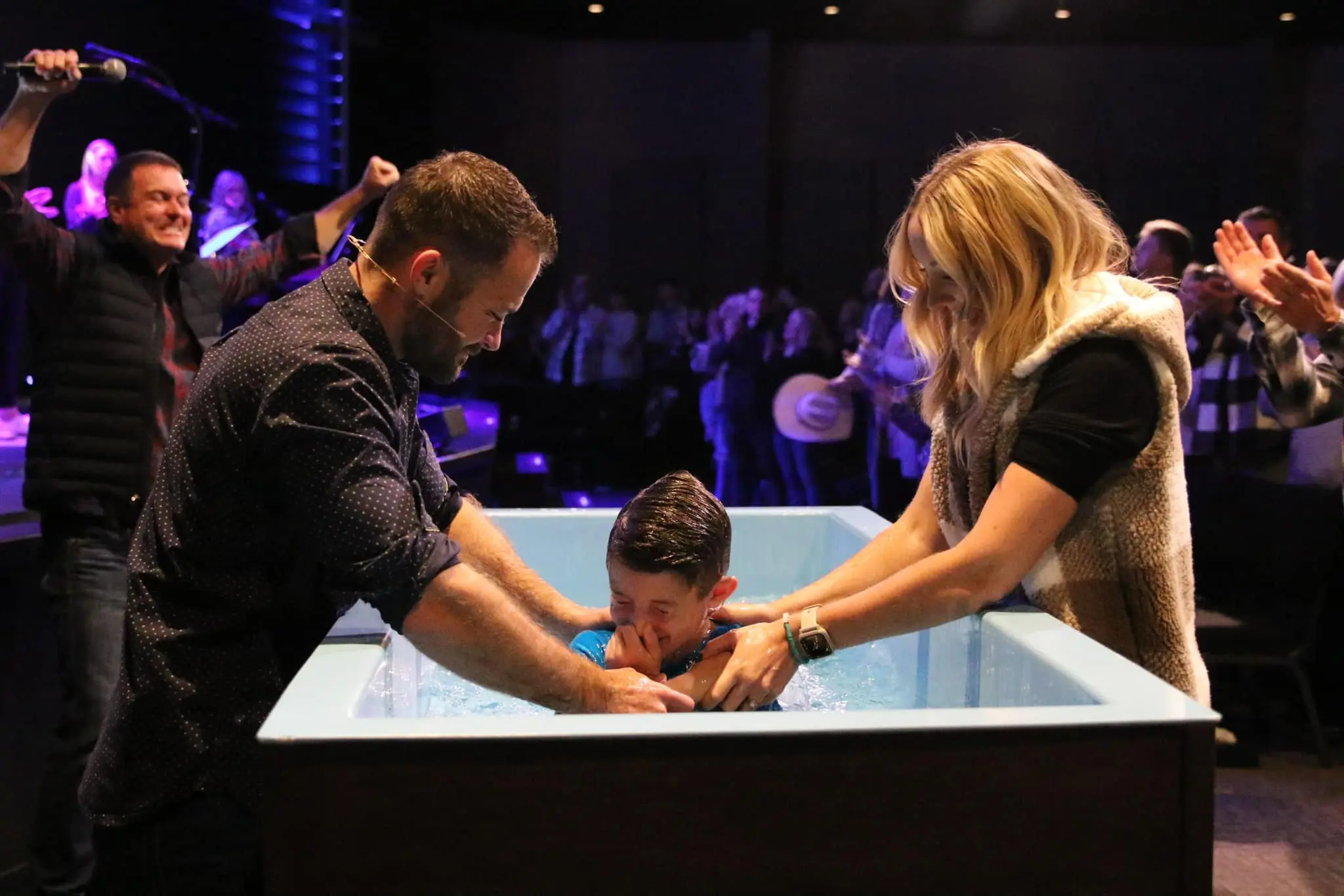 Coach Alex participating in a baptism