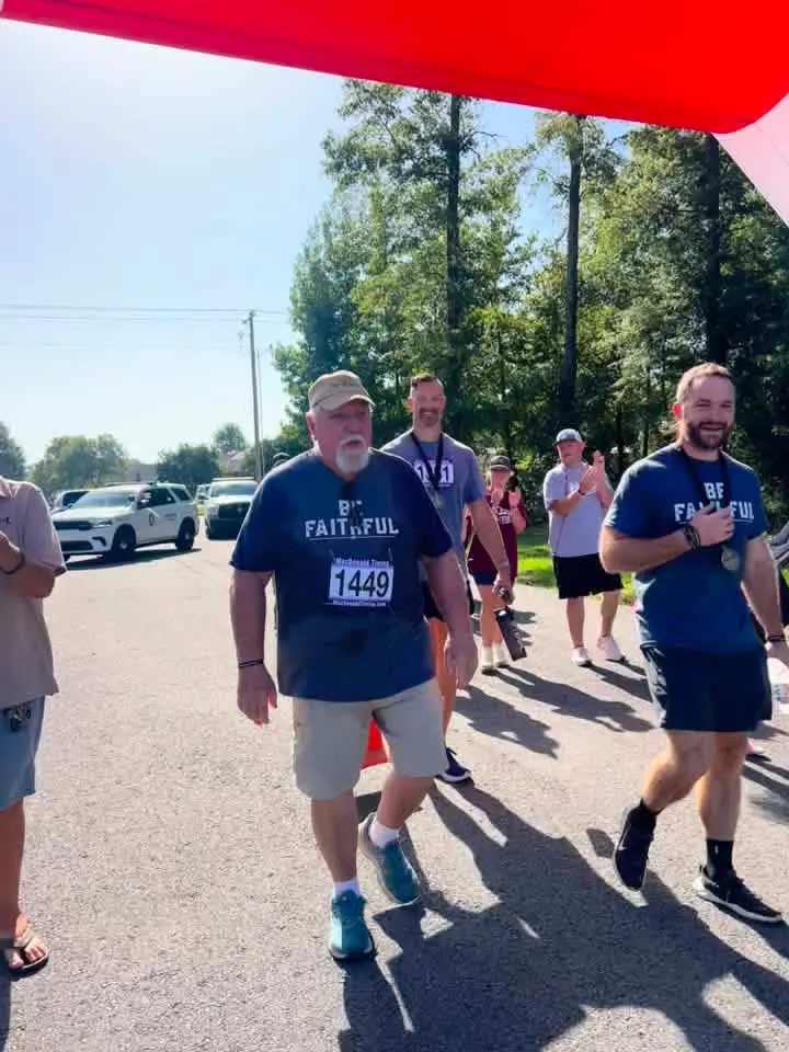 Roy finishing the 2026 Faithful 5K in Greenbrier, Arkansas, with Coach Alex Van Houten